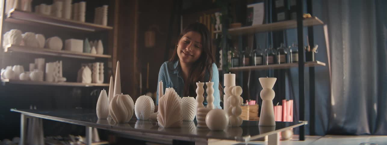 Craftswoman posing with her candle art works with different molds