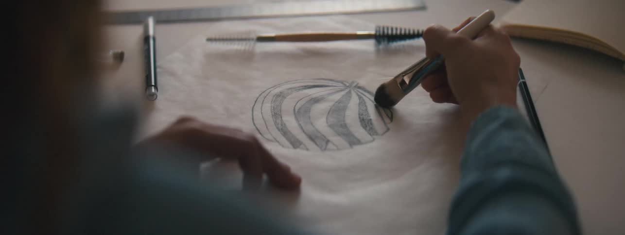 A person is sketching on a paper