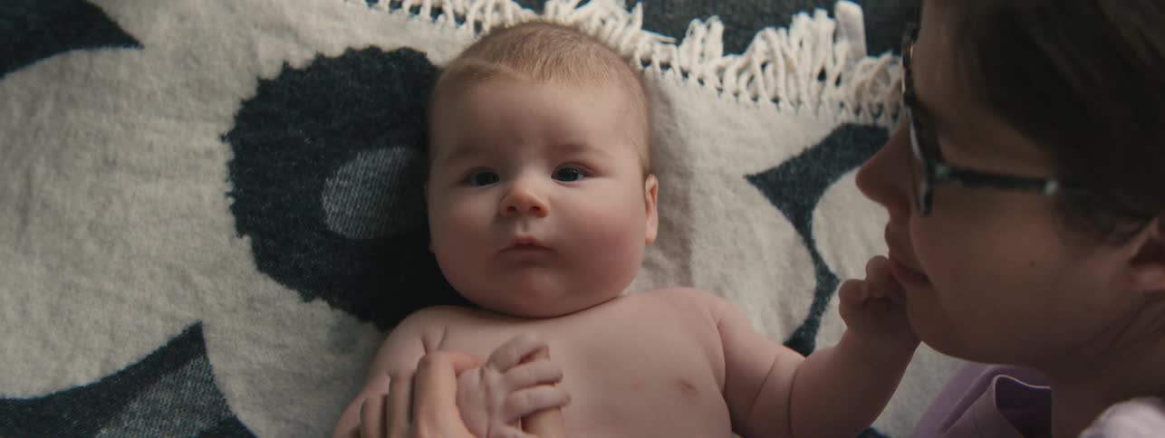 Mother interacting with her newborn baby
