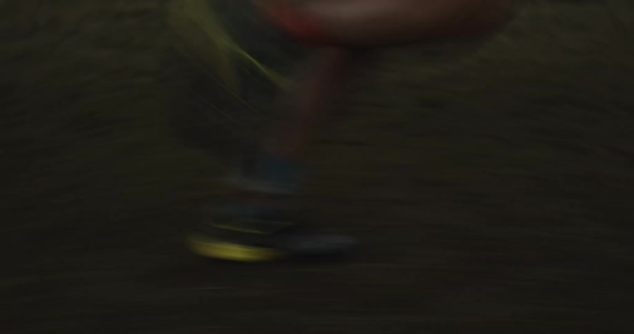 A man is running fast in the grass