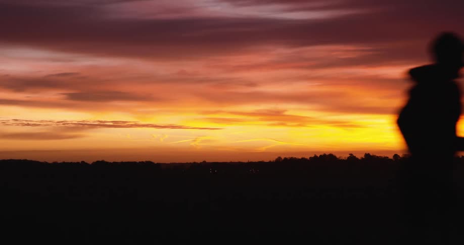 A man is running at sunrise