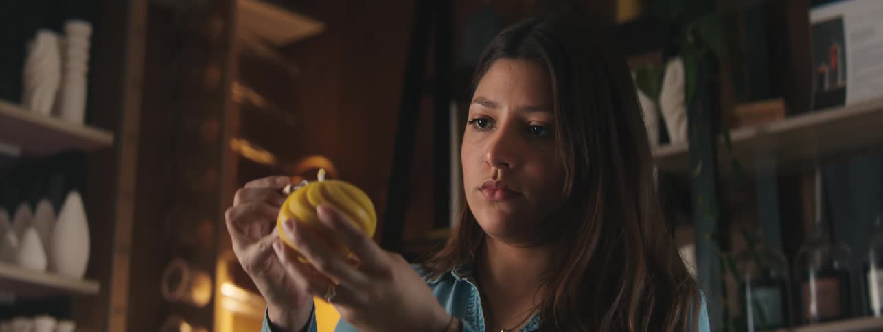 Woman focused on carving a candle