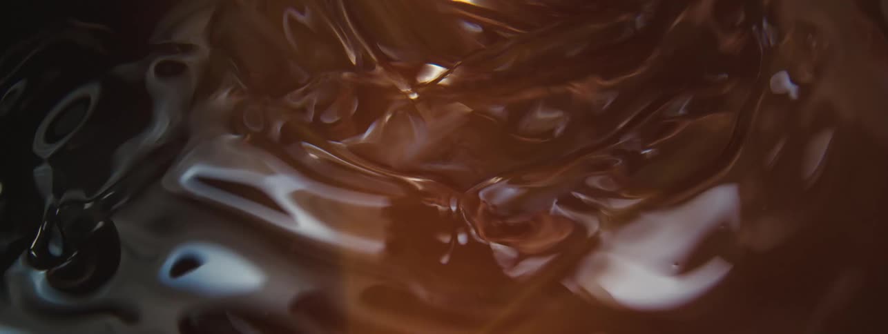 Close up of a brown colored liquid in motion