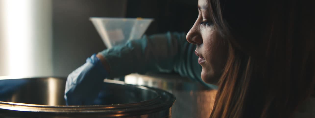 Portrait of a woman working in front of a pot