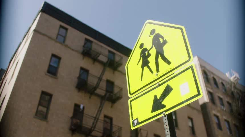 A yellow sign indicating a crosswalk