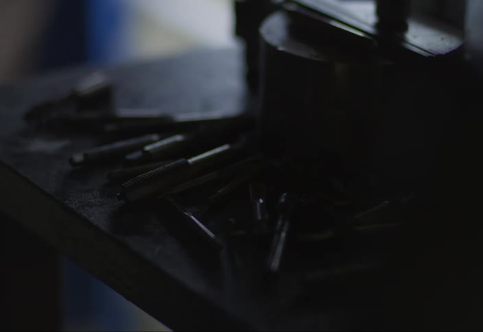 Screws and tools on top of a metal surface