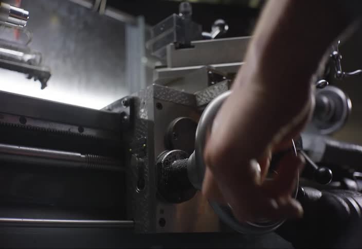 Hand operating a circular piece of machinery