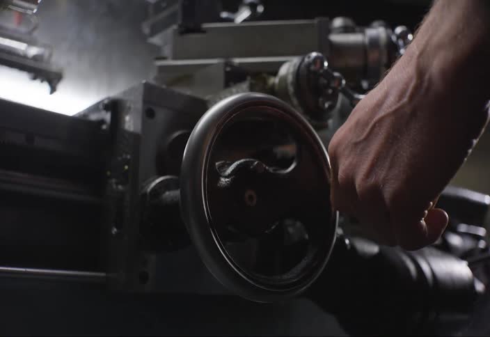 Man controls machine by turning wheels on it