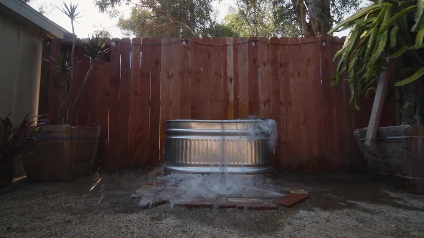 Man jumping into a small bathtub
