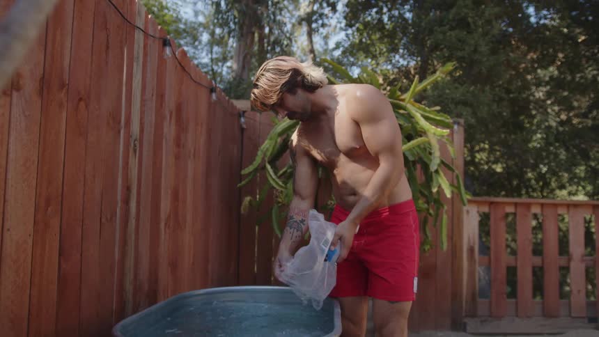 A man fills a tub with ice