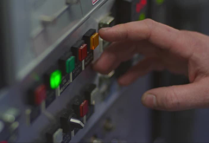 A white male pushes buttons on a machine