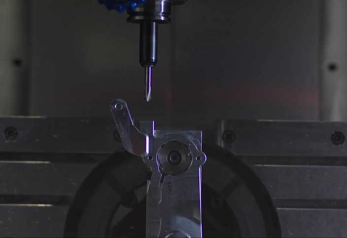 Robotic machine screwing a metal object