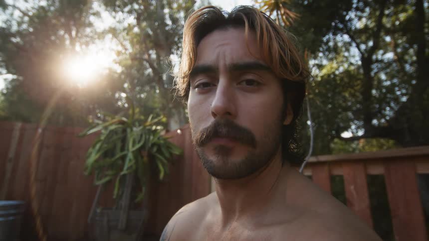 Portrait of a relaxed man in an environment surrounded by greenery