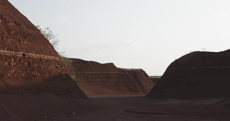 A flat dirt area surrounded by hills of dirt