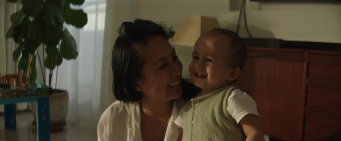 A clip of a mother and son playing and laughing