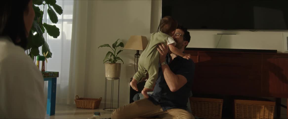 Small child learning to walk and walks towards his father who picks him up