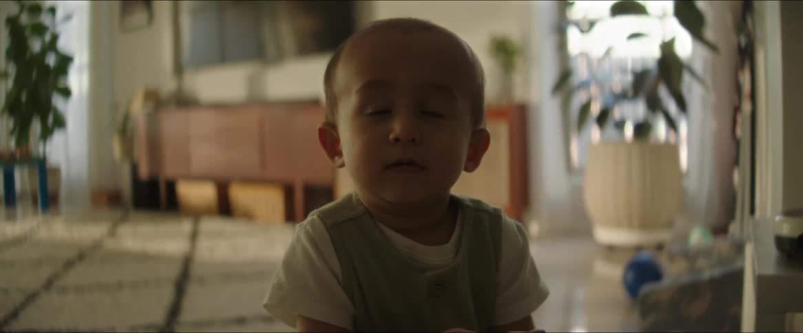 Baby sitting on the living room rug