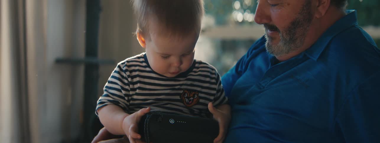 A child is playing with the buttons on a device