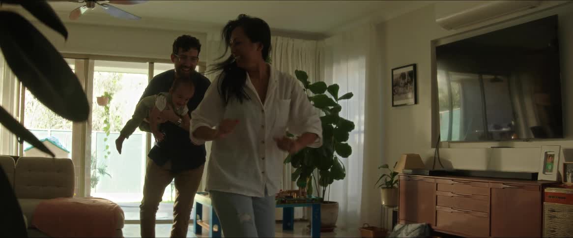 A family play at home with their baby