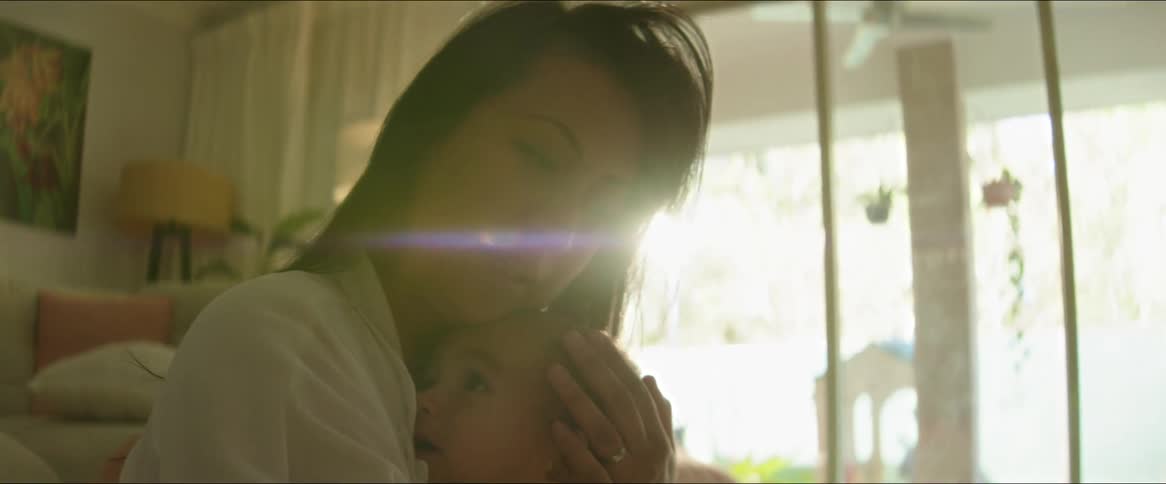 Mother sitting with her baby on her lap