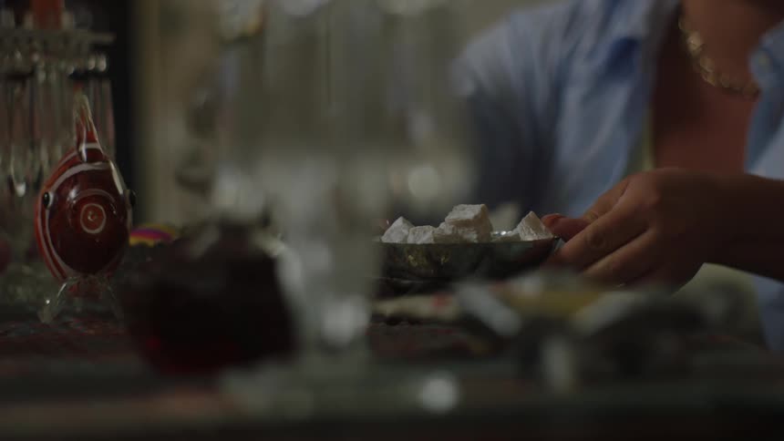 Woman placing a saucer with food on the table