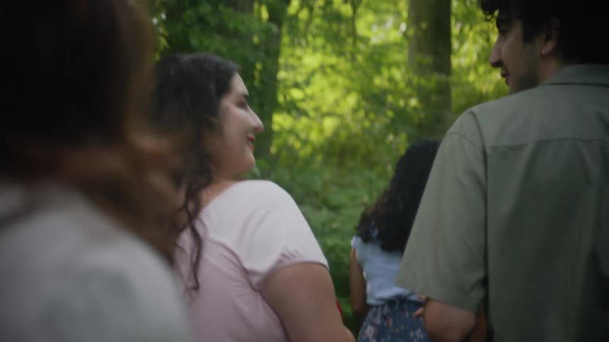Group of friends walking along a trail in the forest