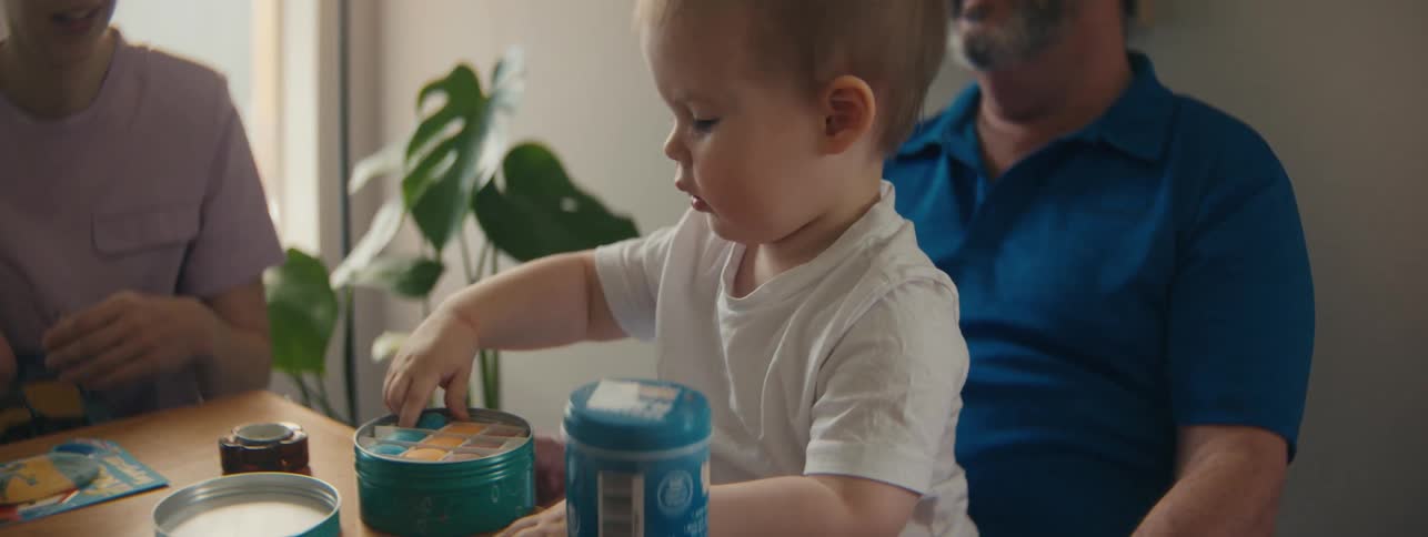A child opens the lid on some toys at home