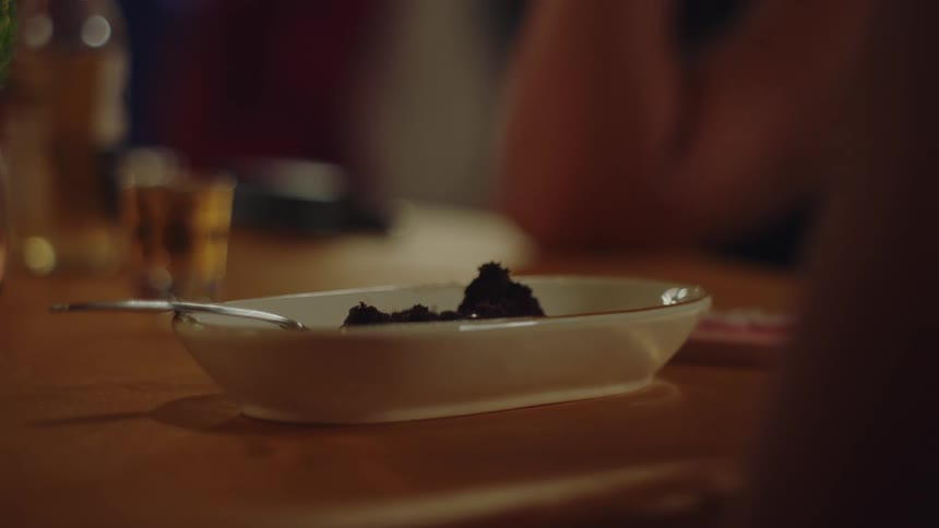 Close up of a ceramic jar with black powder on the table