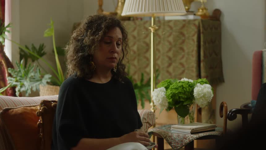 A woman is sitting on a chair at home