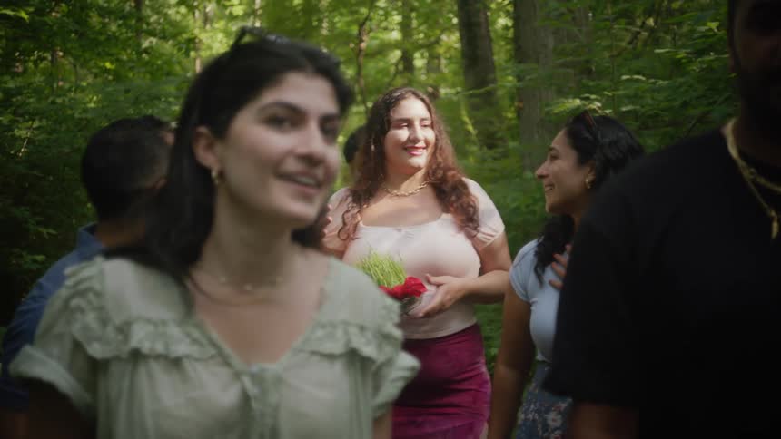 Group of friends chatting happily while walking along a nature trail