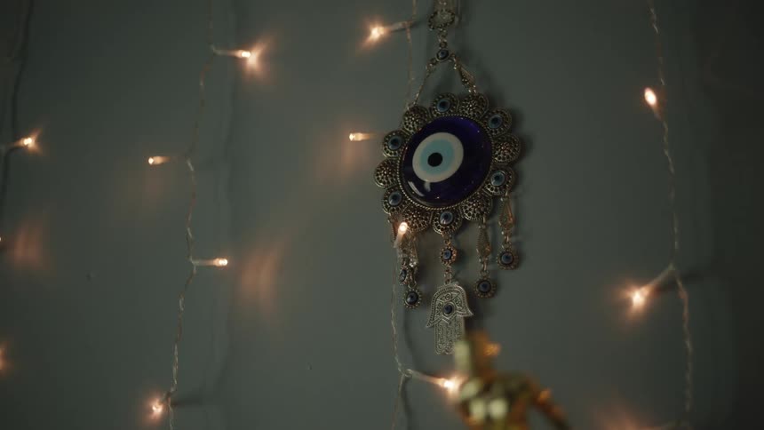 A decoration and statue in a room surrounded by christmas lights