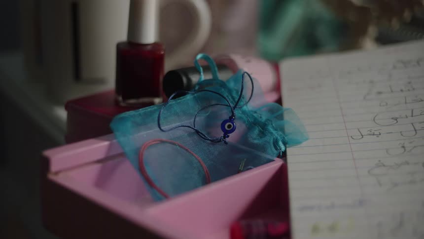 Closeup of paper and a bin standing near nail polish on a flat surface