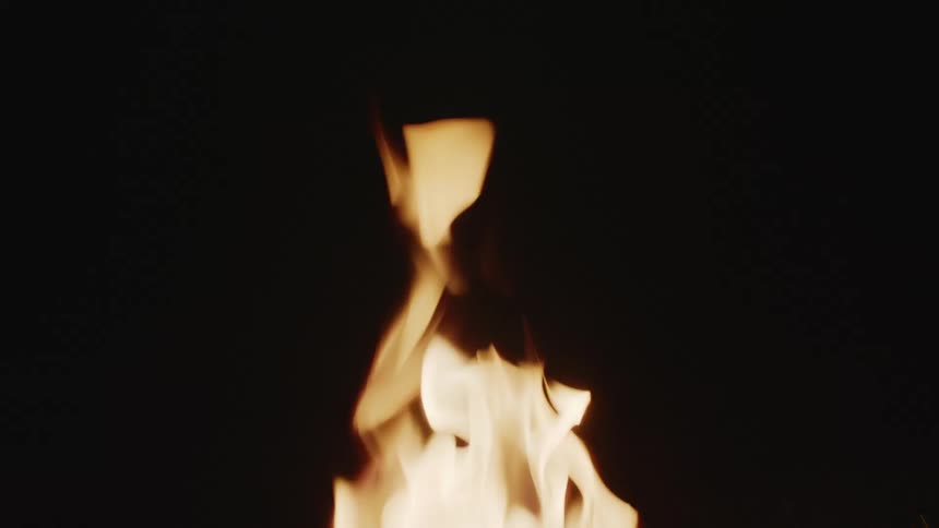 A single flame dances against a dark background