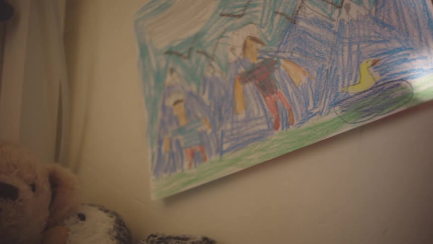 An image of a portrait hanging on the wall
