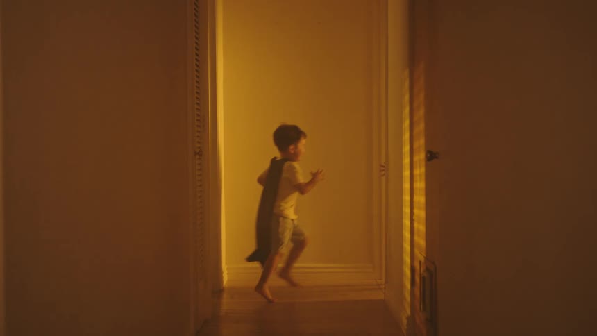 Two boys running in the hallway of the house playing