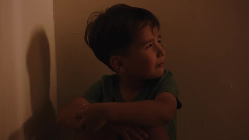 A clip of a kid sitting in fear