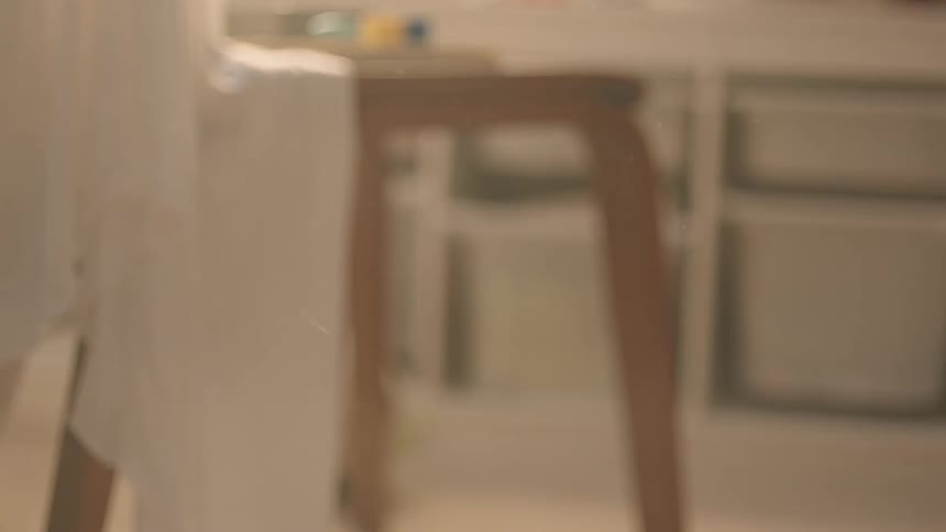 A young boy throws an object across a room