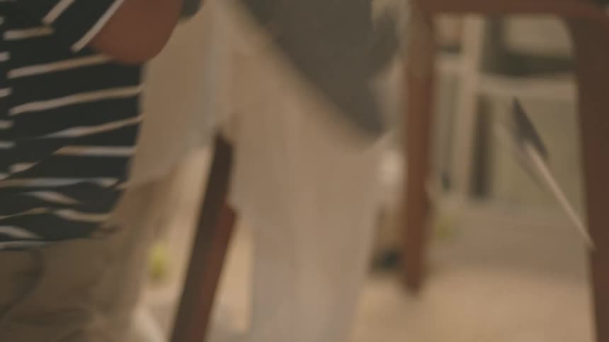 A small boy throws objects inside a room