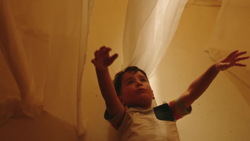 A clip of a child laying on the floor