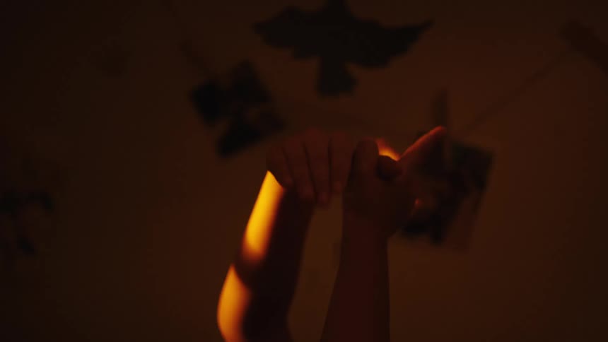 Childs hands casting shadow against the reflection of sunlight