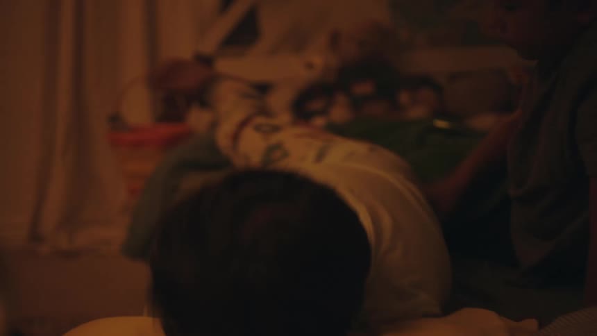 Two boys lying in bed