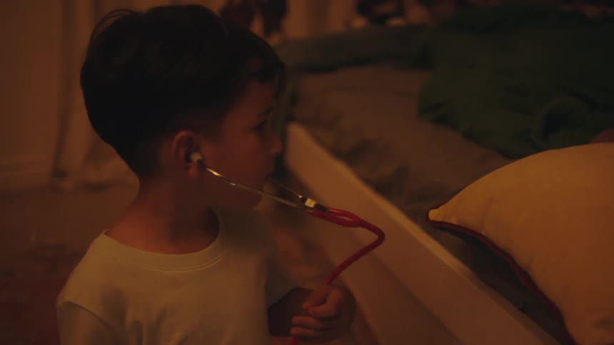 A clip of a kid playing with a stethoscope