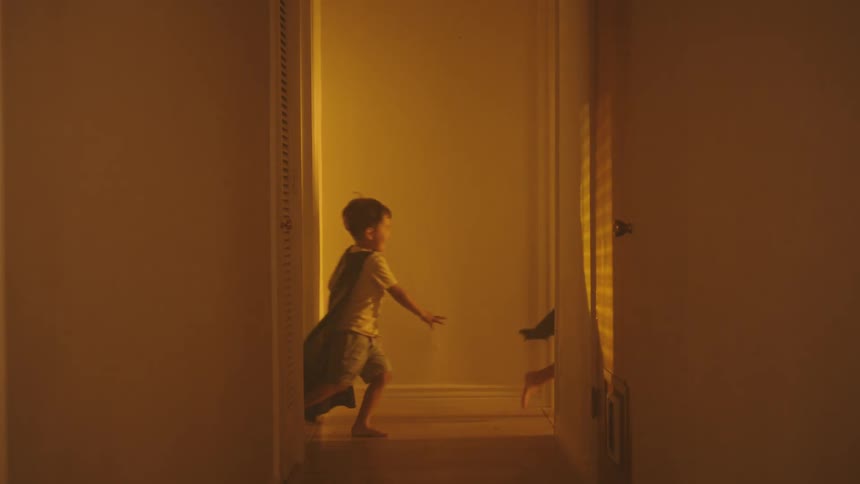 Two boys running in the hallway in the house