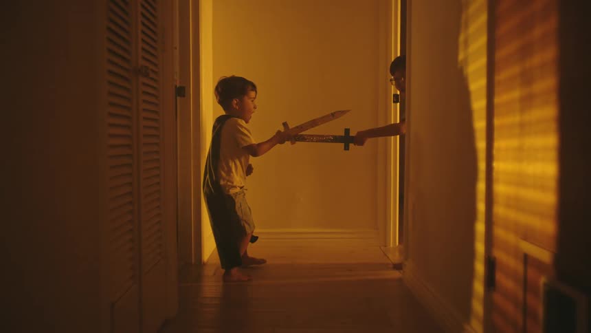 A clip of two brothers playing by the corridor
