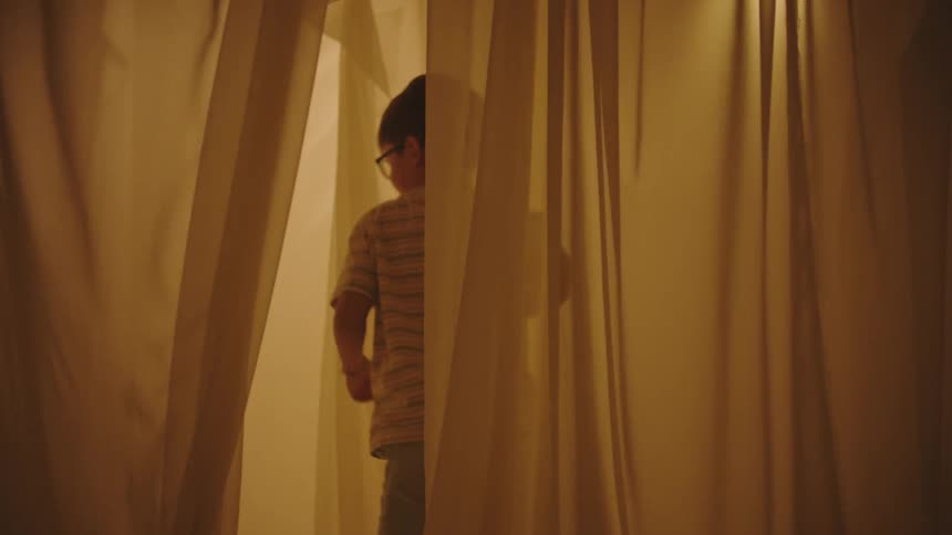A clip of a child running behind the curtain