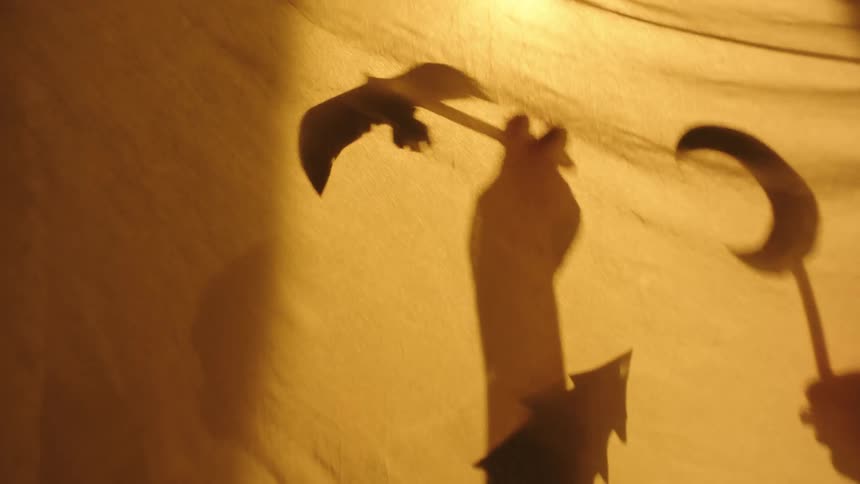 A clip of children demonstrating with toys behind the curtain