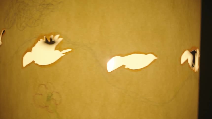 Light bulb shaped like spinning birds