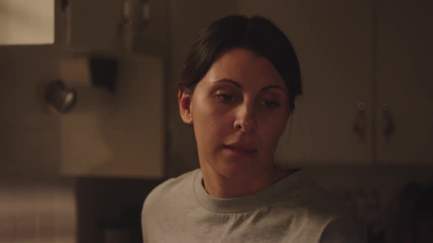 A clip of a nervous woman having a conversation in the house