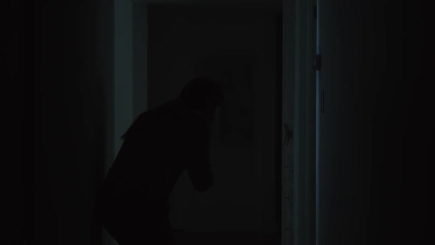 A doctor speaks to a woman who promptly starts crying in a darkened hospital hallway