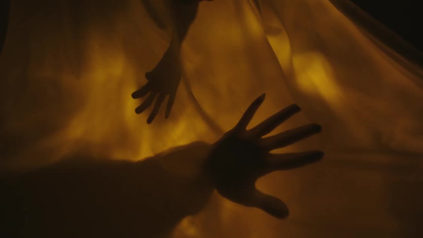 A clip of hands behind a light curtain